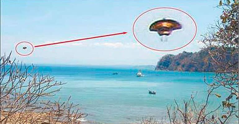 ufo rising from ocean