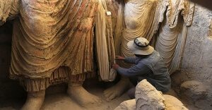 statues examined by archaeologist