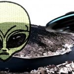 black ufo flying over city