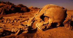 human skeleton buried in desert
